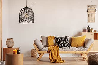 Chic black chandelier above couch in contemporary living room