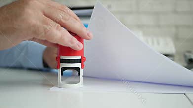 Busy Manager Stamping Some Papers and Documents Using a Rubber Stamp