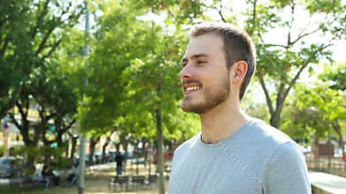 Smiley man breathing fresh air in a park