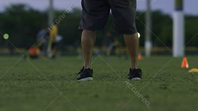 Cool slow motion of kids running by coach during flag football practice