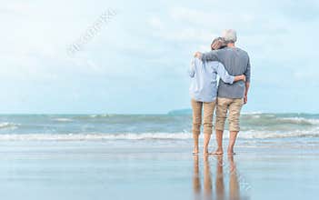 Beautiful happy elderly couple rest at tropical resort,back view
