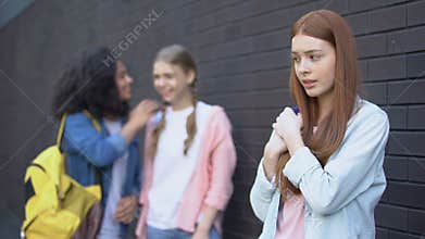 College students gossiping about new red-haired classmate, psychological trauma