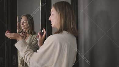 Woman is spraying perfume on wrist