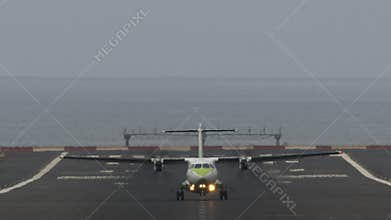 Airliner departure from airport by the ocean