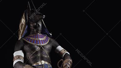 Anubis is wearing ancient egyptian clothes and sitting in a dark room