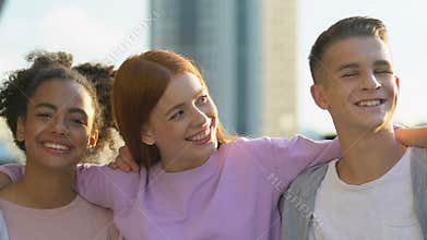 Best multiethnic friends hugging and laughing on camera, strong friendship