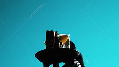 Waitress walking with tray full of cold drinks over blue summer sky