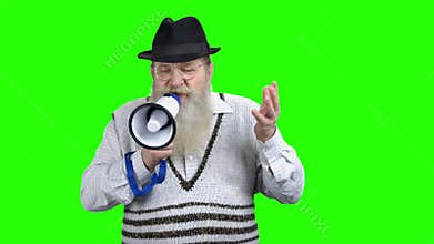 Old man speaking with megaphone on green screen.