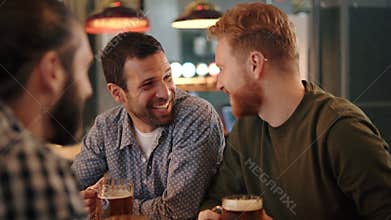 Friends enjoying draft beer at pub