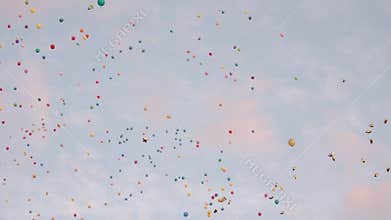 Colorful balloons are flying in the sky. People release balloons.