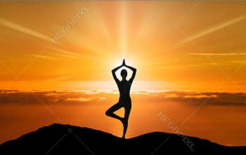 Tree yoga pose, woman silhouette on a cliff meditation at sunset