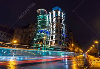 View on a dancing house in Prague, Chech Republic. Light traces made by tram and cars, shot with long exposure by night