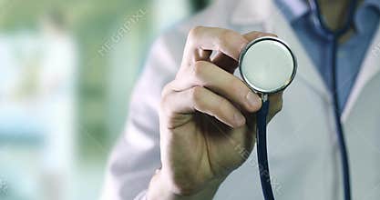 Healthcare and research - doctor standing in clinic hallway with stethoscope in hand
