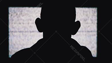Silhouette of an Anonymous Man`s Head is Watching White Static Noise and TV Interference