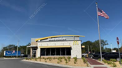 McDonalds exterior with US flag in 4K