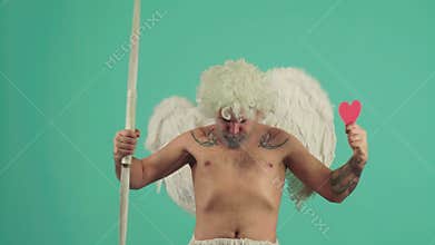 Funny Valentine man giving heart. Valentines Day. Valentine heart concept. Isolated on green.