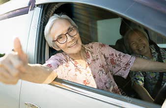 Happy smiling asian senior female driver in her car,enjoy traveling during retirement age with her friend,healthy old people