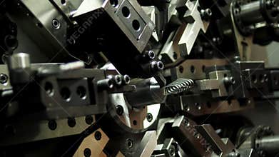 Automated and industrial machine producing springs. Machinery and industry.
