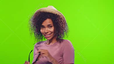Black woman wears straw hat and sunglasses, invites to join vacation, chroma key
