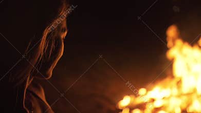 Silhouette of mystic woman in black background of fire fly flame, spark, of contour outline. Outdoor slow motion