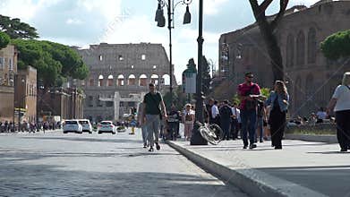 People Walking on a Street near Colosseum in Rome