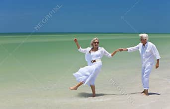 Senior Couple Dancing Holding Hands on A Beach