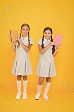Literacy club. Cute children holding books on yellow background. Little girls with encyclopedia or childrens books