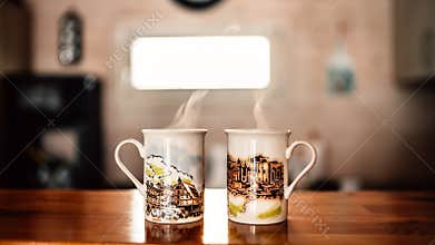 Two cups of hot beverage coffee/tea in the morning.Morning ritual.Caffeine daily routine.Breakfast coffee for two on the kitchen