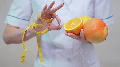 Nutritionist doctor healthy lifestyle concept - holding orange, grapefruit and lemon fruit