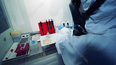 Scientist works with laboratory machine while researching covid-19.