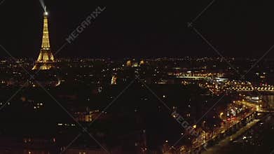 AERIAL: Reverse Drone Flight from Eiffel Tower,Tour Eiffel in Paris, France at Night with City Lights