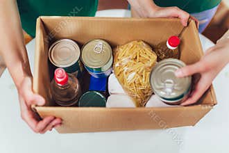 Volunteer with box of food for poor.