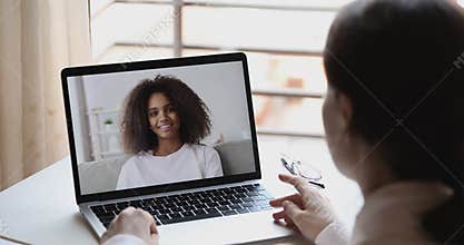 Online teacher or psychologist webcam conferencing with african school girl