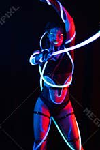 Portrait of a Girl with Glowing Tubes in Neon UF Light. Model Girl with Dreadlocks and Fluorescent Creative Psychedelic