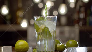 Male hand putting a glass with a tonic on the table