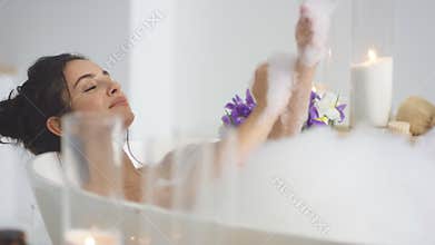 Closeup smiling woman washing hands with foam. Sexy woman relaxing bath