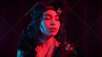 Portrait of woman dressed in style of Great Gatsby flirting and posing on dark