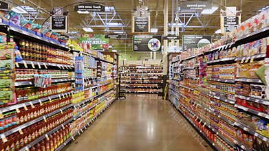 A customers point of view walking down a grocery store aisle.