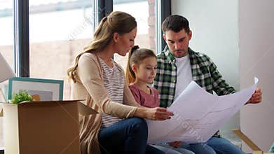 Happy family with blueprint moving to new home