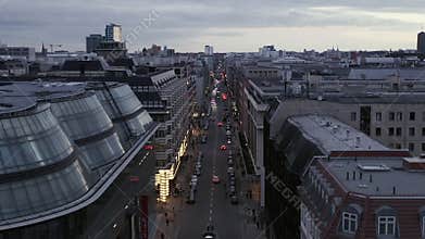 AERIAL: Low View into Berlin Mitte Friedrichstrasse and Car Traffic City Lights, Subway Train Stations on Cloudy Day