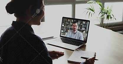 Female student making conference video call talking with teacher