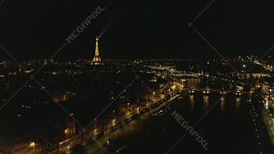 AERIAL: Reverse Drone Flight from Eiffel Tower,Tour Eiffel in Paris, France at Night with City Lights