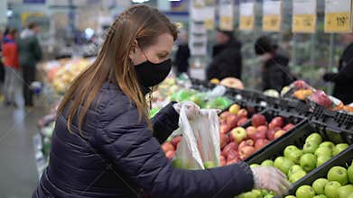 Woman in face protective mask in supermarket grocery store covid-19 coronavirus