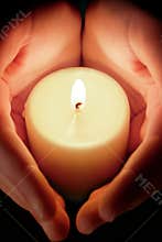Candle between the hands