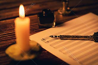 Vintage manuscript - writing musical notes in candlelight