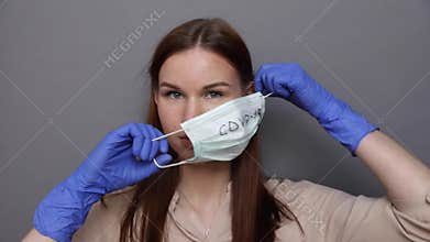 Woman takes off a Surgical mask for protect Covid-19 coronavirus