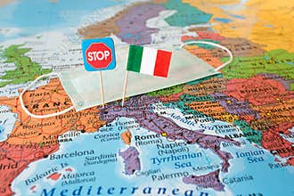 Stop Corona spread concept image, flag of Italy, hygienic face mask and stop sign on map, disease prevention