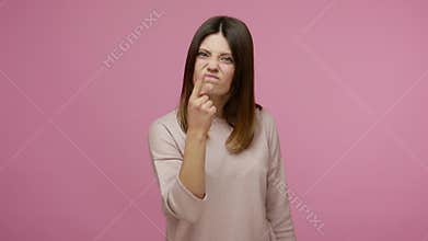 You tell lie! Brunette young woman touching nose and frowning displeased, angry about deception