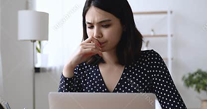 Serious Asian student do assignment preparing for exams using laptop
