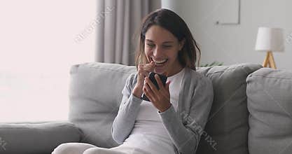 Happy overjoyed girl holding phone celebrate mobile win at home